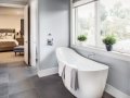 Bathtub in master bathroom in new luxury home with view of master bedroom