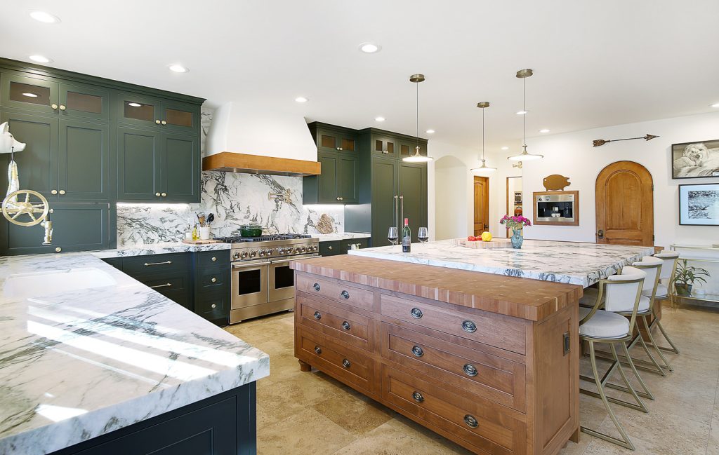 Custom kitchen cabinetry installation showing white painted cabinets with modern hardware